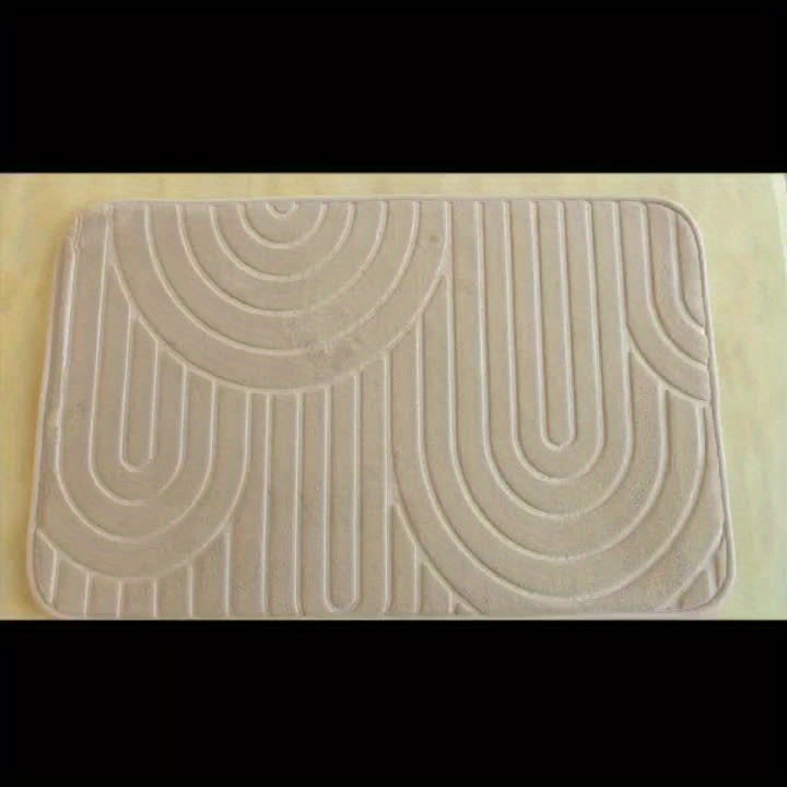 Tapis de bain plié, montrant la flexibilité du polyester