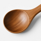 Cuillère et spatule en bois sur fond texturé