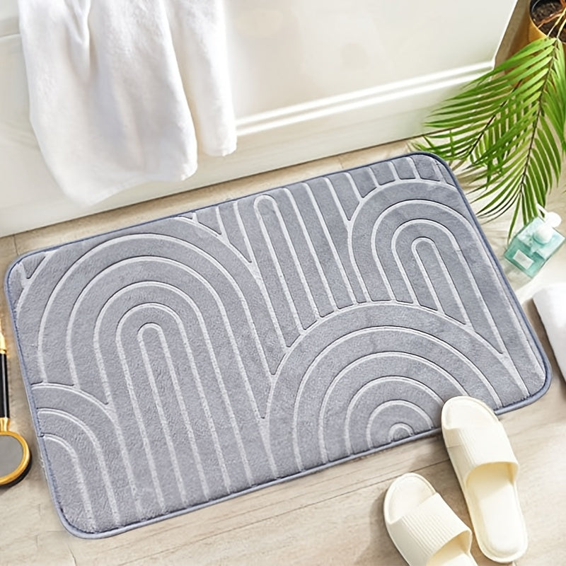 Tapis de bain placé devant une baignoire, ajoutant une touche moderne