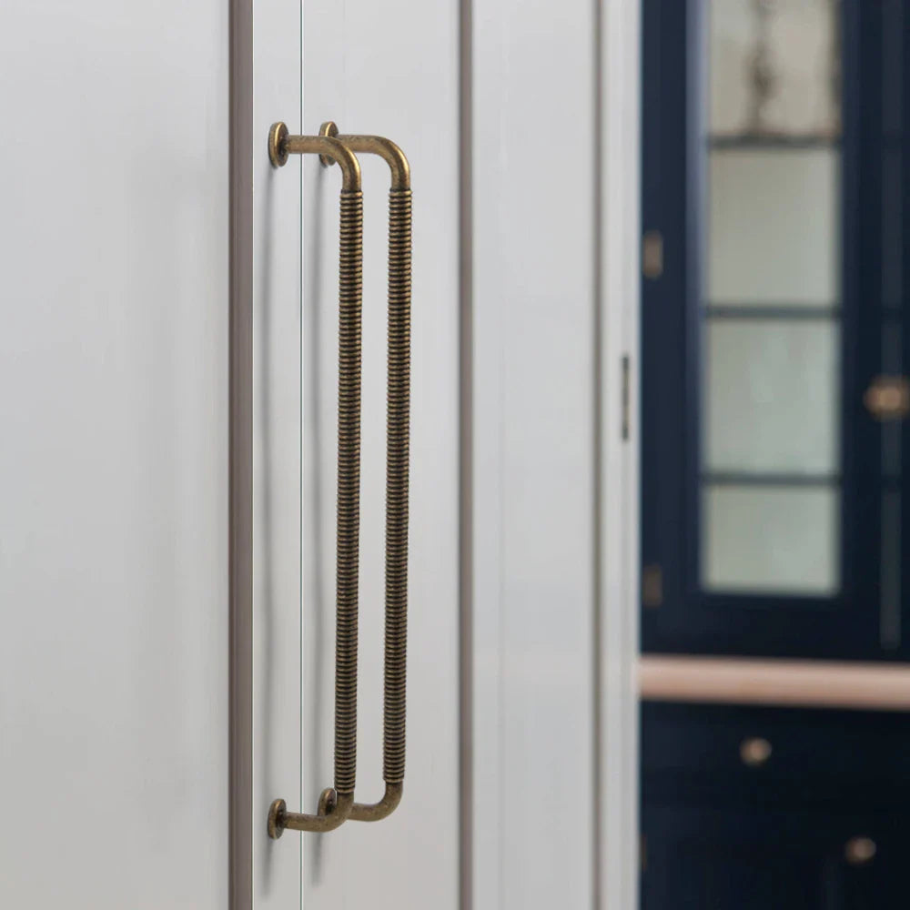 Poignée dorée en aluminium installée sur une armoire